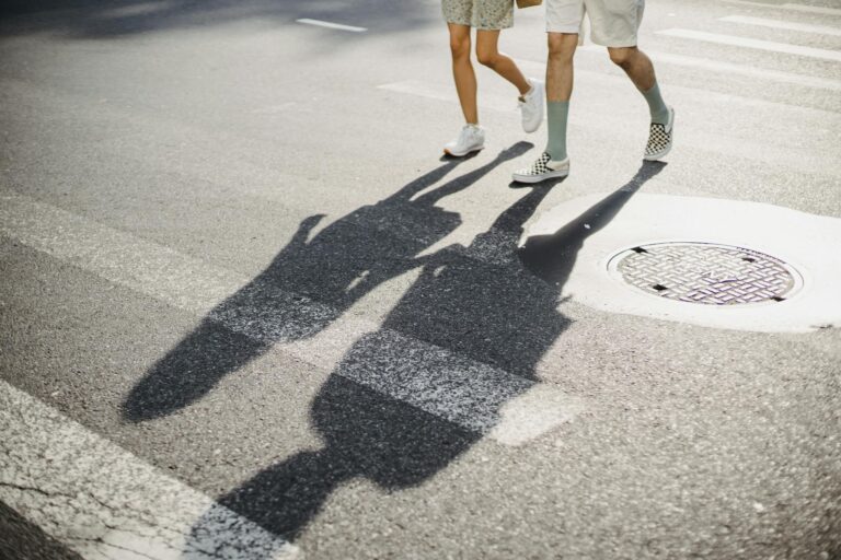 Young couple crossing road on crosswalk